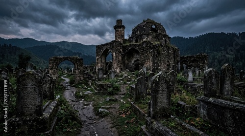 Ancient stone graveyard with weathered tombstones and ruined mosque architecture under a dramatic stormy overcast sky evoking a sense of mystery and historical decay in a remote mountain landscape