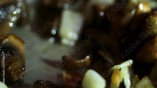 Fresh sliced mushrooms and onions frying in a hot pan with oil