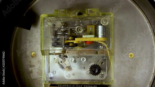 Transparent mechanical clockwork mechanism with gears and internal components inside industrial device casing