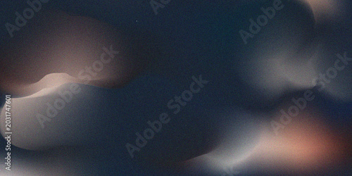 Abstract dark background with soft glowing light flares and grainy texture, creating a mysterious and dreamy atmosphere for artistic design projects.