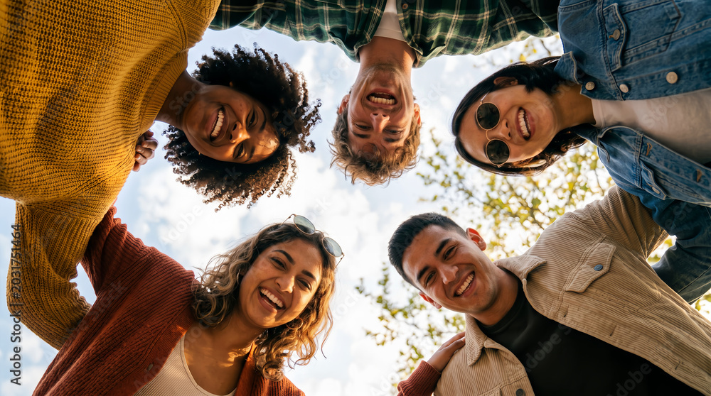 Obraz premium Diverse Group of Happy Young Friends Smiling Together Outdoors for Friendship and Community Lifestyle Concept
