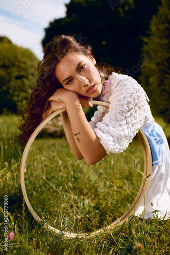 фотографія Whimsical woman lost in a vibrant garden, embracing natures charm and grace