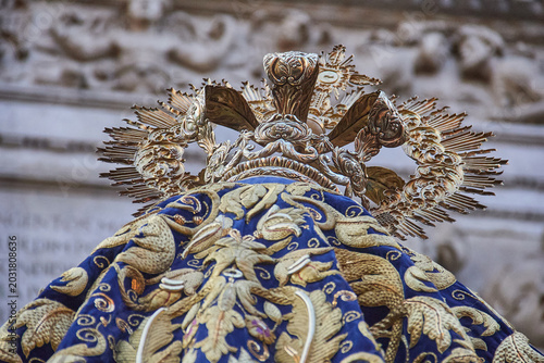 Slika na platnu Low angle detail of ornate crown and embroidered mantle on processional sculptur