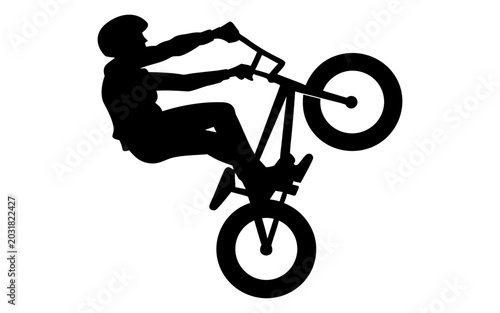 Obraz na płótnie Silhouette of a BMX rider performing a wheelie stunt isolated on white backgroun