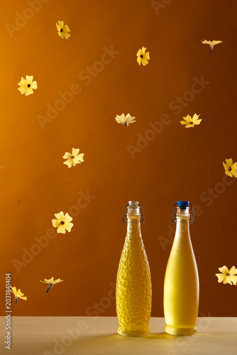 bottles of home made limonchello with yellow flowers