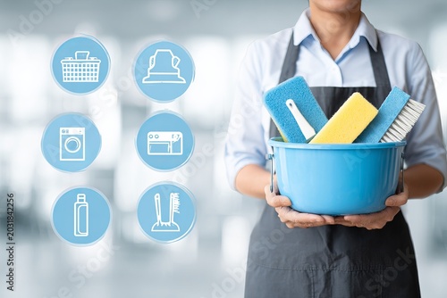 Cleaning service professional holding cleaning supplies with cleaning icons.
