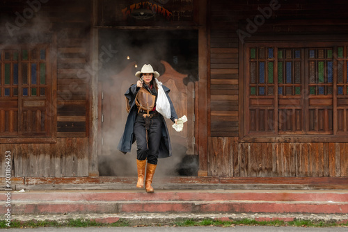 Photos Cowboy standoff abandoned town action shot dusty environment side view tension a