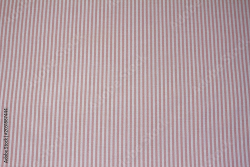 Texture of pink striped cotton cloth background. Close up of classic pink and white vertical striped fabric.