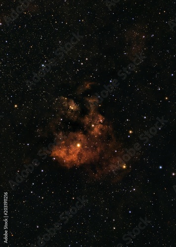 Vibrant red emission nebula glowing brightly among numerous distant stars scattered across the vast dark cosmos.