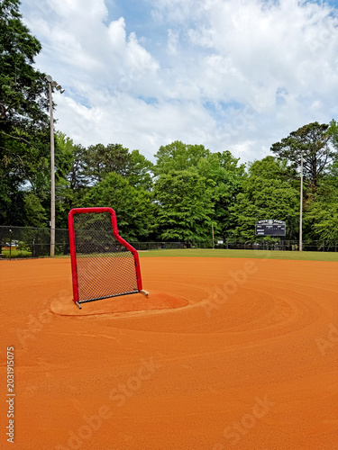 Schilderij op canvas Baseball protective L-screen net on pitcher mound of infield dirt