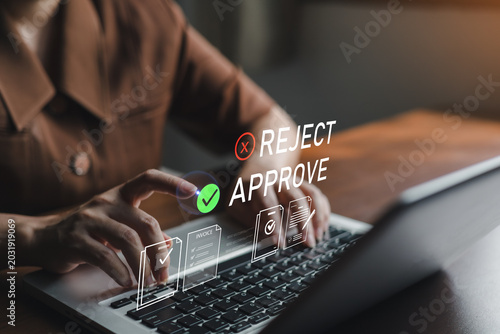 Valokuva Business professional approving online documents on laptop with digital approve and reject interface,representing workflow automation, invoice management,compliance verification and paperless office