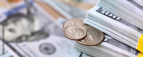 Photography US coin lies among ten thousand dollars packs in stack on big amount of hundred