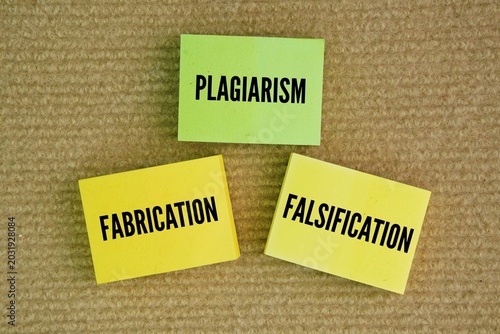 Paper with the words Plagiarism, Fabrication, Falsification. the three 