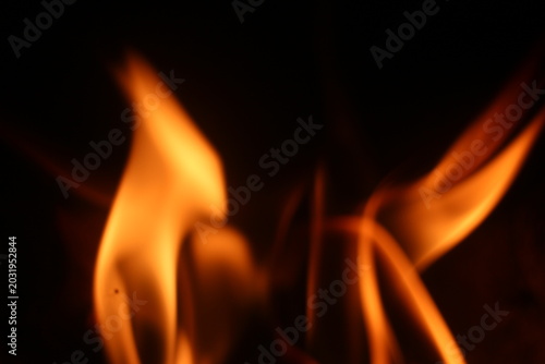 Close Up of Firewood Burning with Golden Flames in a Traditional Stove