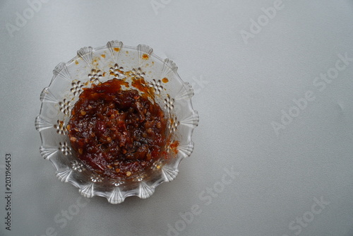 Foto A bowl of chili sauce, also known as sambal, made from hot chilies is pictured directly above the object, isolated against a white background