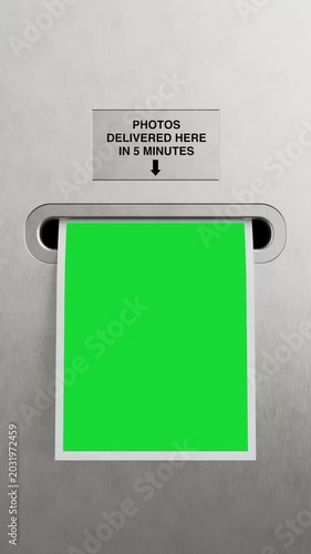 4k Resolution Vertical Video for Social Media: Instant Photo Printing Service Concept With Photo Booth Output Slot. Blank Green Screen Photo Template Coming Out Of Machine Extreme Closeup