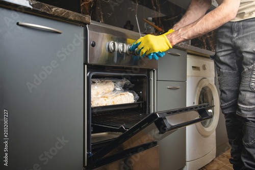 Caucasian master repairs of gas stove.