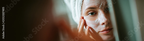 Skincare face mask beauty spa relaxation wellness woman bathroom mirror skincare face mask beauty spa relaxation wellness woman bathroom mirror, calm young adult with towel wrapped hair gently