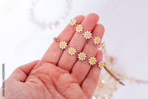 Hand holding daisy flower bracelet jewelry close up