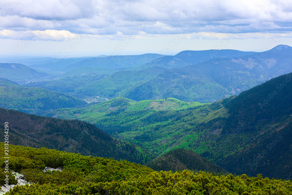 Obraz premium Green mountains and rocks scenery. Eco travel, hiking concept. Bright green colors in highland. Hiking equipment background ad.