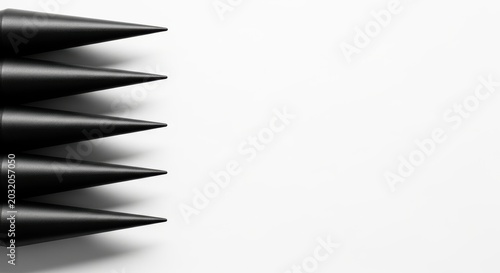 Four black pointed objects arranged vertically on left side against white background with shadows ideal for minimalist design elements