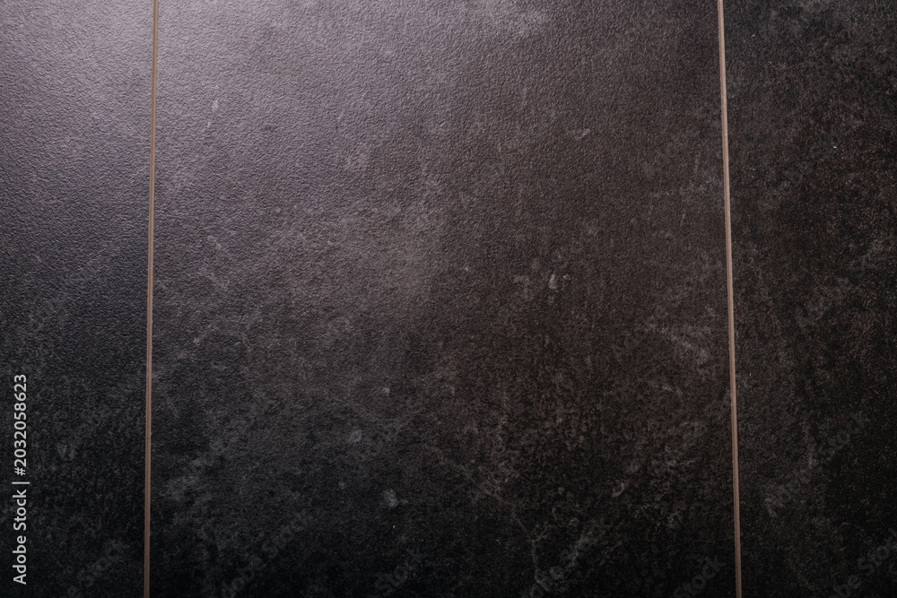 Fototapeta premium Dark textured wall surface with vertical panels and grunge pattern