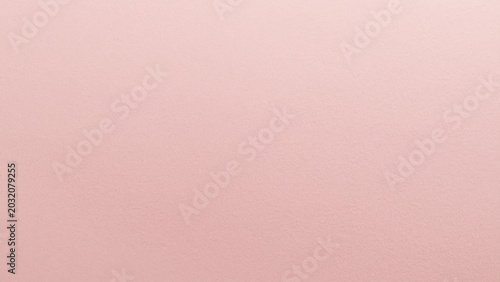 Pale pink textured paper background, soft and uniform coloration.