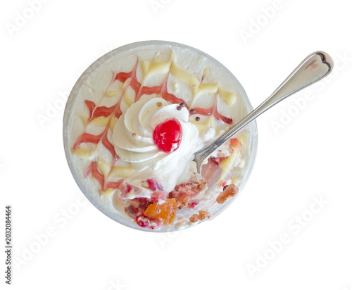 Cup of fresh berries, cake and cream with a spoon