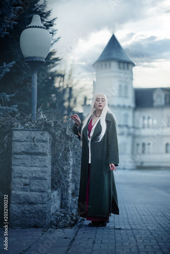 A gothic fantasy character with pale skin and long hair against a castle background.