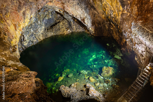 Underground clear water lake inside the Algar do Carvao volcanic cave and lava tube on Terceira Island, Azores, Portugal.