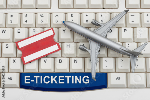 Fotografie E-ticketing text with an airplane and ticket on a white computer keyboard for bo
