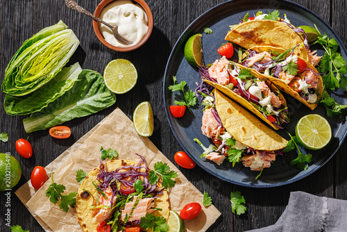 salmon tacos drizzled with sauce on a plate