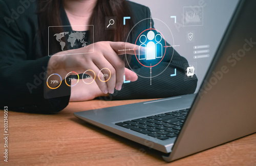 Business hand pointing at digital target audience icon with AI analytics, global data, and performance metrics, representing customer segmentation, user targeting, data-driven marketing