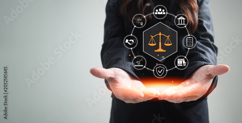 Photos Business professional holding digital legal compliance and governance interface