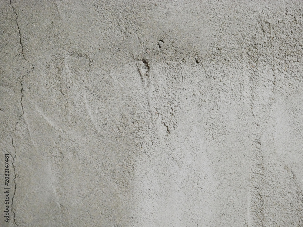 Fototapeta premium Gray concrete wall with rough textured surface. Cement background for construction or industrial design. Solid material detail for architecture, renovation, and home building project.