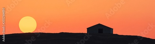 Minimalist Silhouette Elongated Golden Sun and Isolated Hut on Hilltop, Bathed in a Vibrant Orange DawnDusk Sky, Evoking Surreal Tranquility. Solitude, Serene