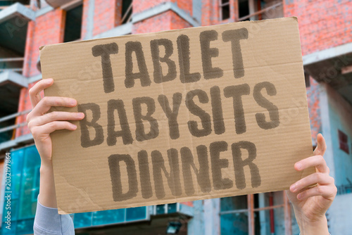 Foto "Tablet Babysits Dinner" Devices occupy children during meals
