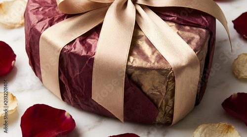 Gift Wrapping Holiday Present with Gold Ribbon on Marble Background for Festive Celebration
