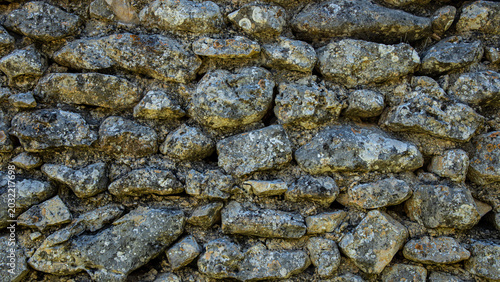 Φωτογραφία Close up of the texture of an ancient dry stone wall in a Moorish village in rur