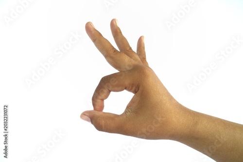 Photos The OK hand gesture is formed by bringing the tips of the thumb and index finger together in a circle, while the other fingers remain straight or relaxed