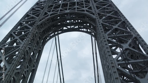 point of view of car driving over george washington bridge between fort lee new jersey and manhattan york heights (sunset night time cloudy suspension bridge)