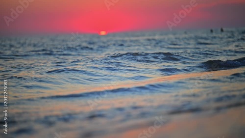 Peaceful beach wave under glowing evening sky, tranquil nature footage in 4K.