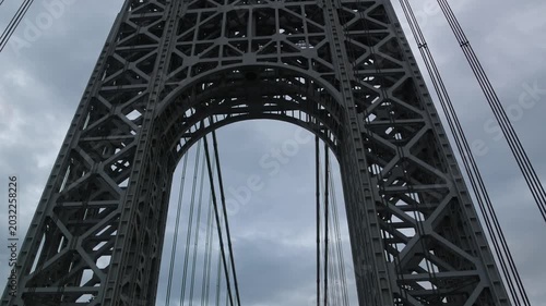 point of view of car driving over george washington bridge between fort lee new jersey and manhattan york heights (sunset night time cloudy suspension bridge)