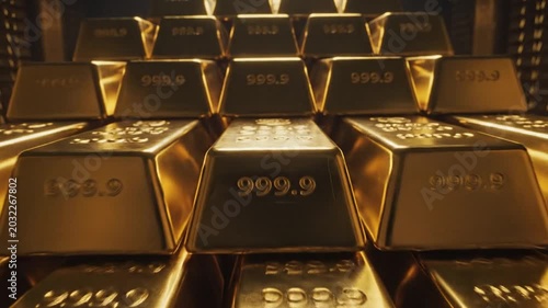 Close up of shiny gold bars with number details in strong lighting