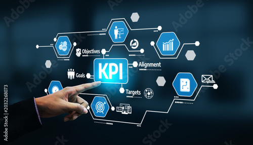 Fotografie A business professional interacts with a digital display of KPI graphics, showcasing essential elements of objectives, targets, and analytics for performance evaluation
