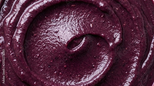 Close-up of creamy acai puree swirl, healthy fruit dessert texture macro close-up, food detail, natural background