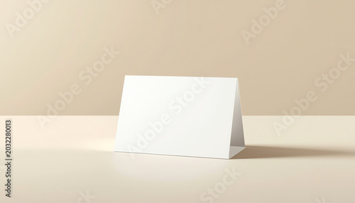 Realistic white blank folded paper card standing on wooden table top