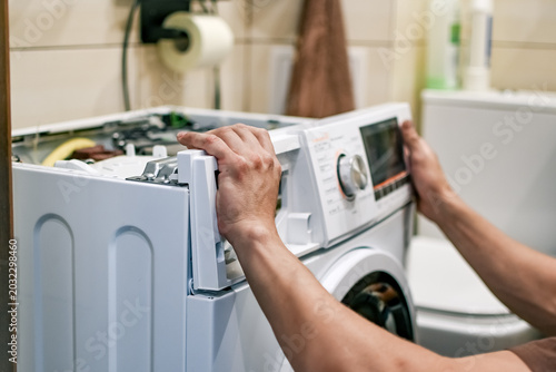 Obraz na plátne A front-loading washing machine repair in progress