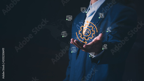 Canvas Print Businessman presenting customer service and business automation concept with gear icons on a world map, Illustrating global technical support, call center solutions, and non-stop operations