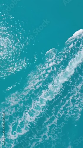 Shoot down at the white waves on the sea surface